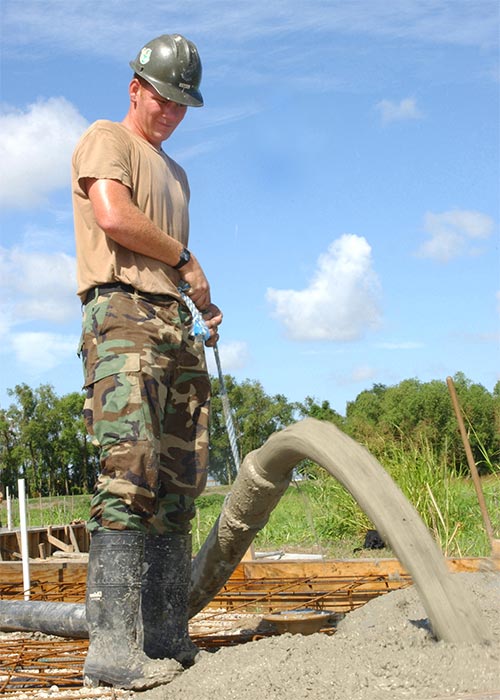 Man pumping concrete from hose